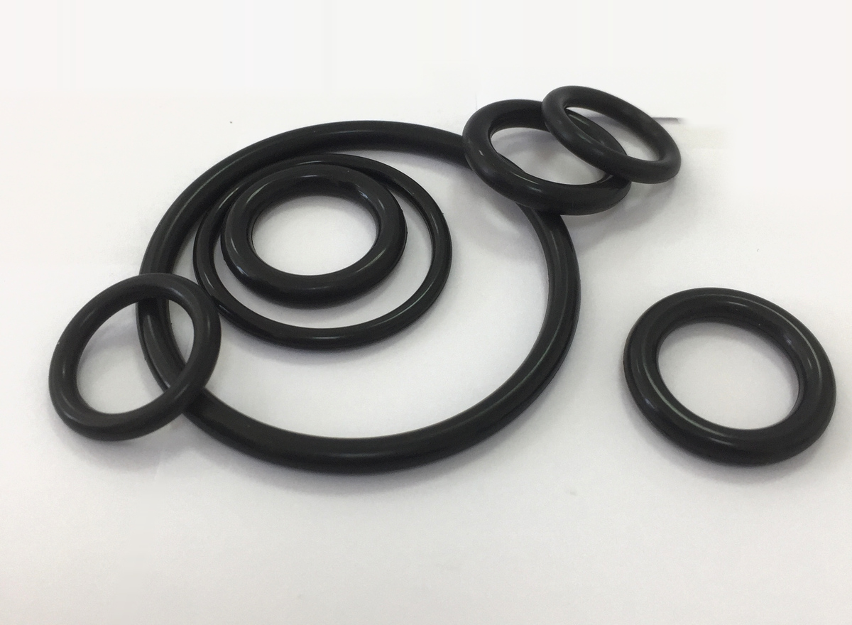 Three nested black EPDM O-rings at the center, with other O-rings arranged around them