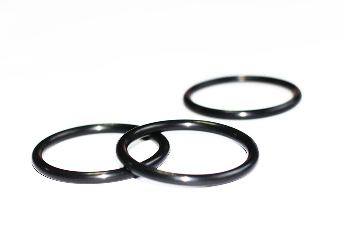 Three black PTFE-coated O-rings, with two overlapping in the foreground